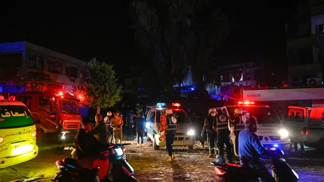 epa11673802 Members of an emergency crew gather at a site near the Rafik Hariri University Hospital (RHUH), following Israeli airstrikes in the Jnah District of Beirut, Lebanon, 21 October 2024. According to the Lebanese Ministry of Health, more than 2,400 people have been killed and over 11,600 others have been injured in Lebanon since the start of recent escalations of hostilities. EPA/STR