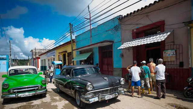 epa11676392 Classic vehicles drive down a street in the town of Bejucal (26 km south of Havana), Mayabeque province, Cuba, 22 October 2024. Cuba's state-owned company Union Electrica (UNE) reported on 22 October that it has managed to complete the reconnection of the entire country to the National Electric System (SEN), four days after the total blackout that the island sufferedon 18 October. EPA/Yander Zamora