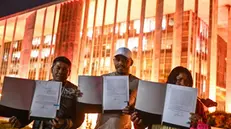 epa11678952 Indigenous people hold their demarcation documents after the signing ceremony for the decree demarcating new lands, in front of the Ministry of Justice, in Brasilia, Brazil, 23 October 2024. The Brazilian Government signed a directive to delimit seven new indigenous lands of the Guarani in the industrialized state of Sao Paulo, which together add up to an area of nearly 20,000 hectares. The demarcated indigenous territories are: Jaragua, Peguaoty, Djaiko-aty, Amba Pora, Pindoty-Araca Mirim, Tapy'i-Rio Branquinho and Guaviraty, according to an Executive document to which EFE had access. EPA/ANDRE BORGES