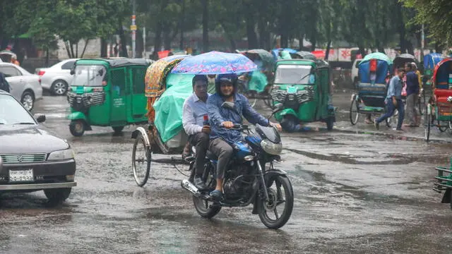 epa11679919 A man holds an umbrella on a motorbike during a rainfall in Dhaka, Bangladesh, 24 October 2024. According to the Bangladesh Meteorological Department (BMD) and the Indian Meteorological Department (IMD), severe cyclonic storm Dana landfall is expected between late 24 October and early 25 October. BMD has issued a warning regarding the peripheral effects of a severe cyclonic storm Dada, which could cause significant surges along the country's coastal regions. EPA/MONIRUL ALAM