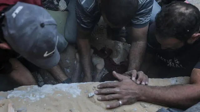 epa11668048 Palestinians recover victims from the rubble of the destroyed house of the Shnaa family following an Israeli air strike in Al-Maghazi refugee camp in the Gaza Strip, 19 October 2024. According to a report from the Ministry of Health in Gaza, at least eight members of the Shnaa family were killed following an Israeli air strike in the camp. More than 42,500 Palestinians and over 1,400 Israelis have been killed, according to the Palestinian Health Ministry and the Israel Defense Forces (IDF), since Hamas militants launched an attack against Israel from the Gaza Strip on 07 October 2023, and the Israeli operations in Gaza and the West Bank which followed it. EPA/MOHAMMED SABER