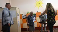 epa11398935 A woman (C) votes at a polling station during the country's parliamentary elections and the European elections in Sofia, Bulgaria, 09 June 2024. Bulgaria votes for a national and European parliament. The sixth consecutive election in the last four years was held after the leaders of GERB (Citizens for European Development of Bulgaria) and 'We Continue the Change - Democratic Bulgaria' (PP-DB) did not reach an agreement on their joint governance. EPA/VASSIL DONEV