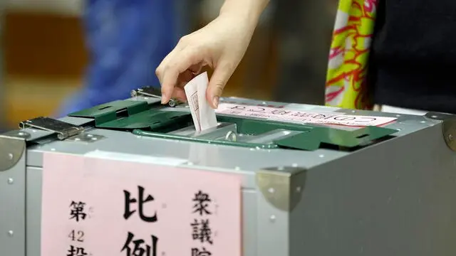 epa11686249 A woman casts her ballot during the general election at a polling station in Tokyo, Japan, 27 October 2024. Following the dissolution of the parliament by Japan’s Prime Minister Shigeru Ishiba, voters are called for elections of the house of representatives (the lower house). EPA/FRANCK ROBICHON