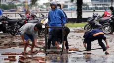 epa11688536 A handout photo made available by Vietnam News Agency shows people cleaning the road after tropical Storm Trami made landfall in Da Nang, Vietnam, 27 October 2024 (issued 28 October 2024). Tropical Storm Trami made landfall on 27 October, killing two people, according to state media. EPA/VIETNAM NEWS AGENCY/HANDOUT HANDOUT HANDOUT EDITORIAL USE ONLY/NO SALES