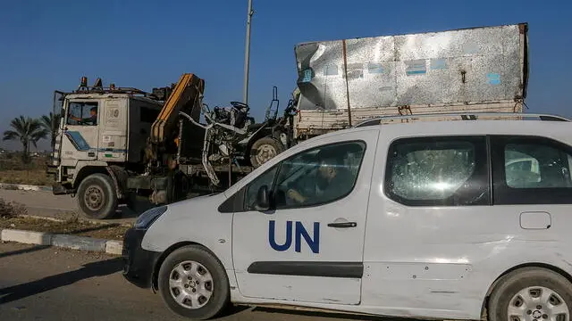 epa11677171 A destroyed truck that was used by workers of the United Nations Relief and Works Agency for Palestine Refugees (UNRWA) is loaded onto another truck after it was hit in an Israeli air strike on Salah Al Dine road between Deir Al Balah and Khan Younis town southern Gaza Strip, 23 October 2024. According to Palestinian officials and the Health Ministry in Gaza, two Palestinian workers of the United Nations Relief and Works Agency for Palestine Refugees (UNRWA) were killed after an Israeli air strike on 23 October. More than 42,600 Palestinians and over 1,400 Israelis have been killed, according to the Palestinian Health Ministry and the Israel Defense Forces (IDF), since Hamas militants launched an attack against Israel from the Gaza Strip on 07 October 2023, and the Israeli operations in Gaza and the West Bank which followed it. EPA/MOHAMMED SABER