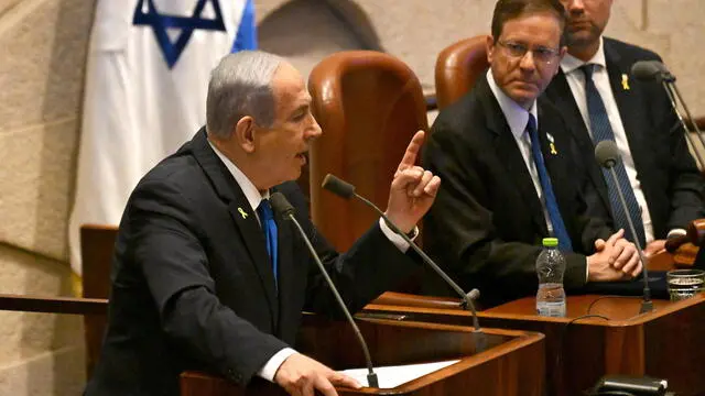 epa11689132 Israeli Prime Minister Benjamin Netanyahu (L) speaks at the opening of the 25th Knesset session as Israeli President Isaac Herzog (C) listens in Jerusalem, 28 October 2024. Israel opened its Knesset session marking the anniversary of the 'Swords of Iron' war, Israel's ground operations in the Gaza Strip. More than 43,000 Palestinians and over 1,400 Israelis have been killed, according to the Palestinian Health Ministry and the Israel Defense Forces (IDF), since Hamas militants launched an attack against Israel from the Gaza Strip on 07 October 2023, and the Israeli operations in Gaza and the West Bank which followed it. EPA/DEBBIE HILL / POOL