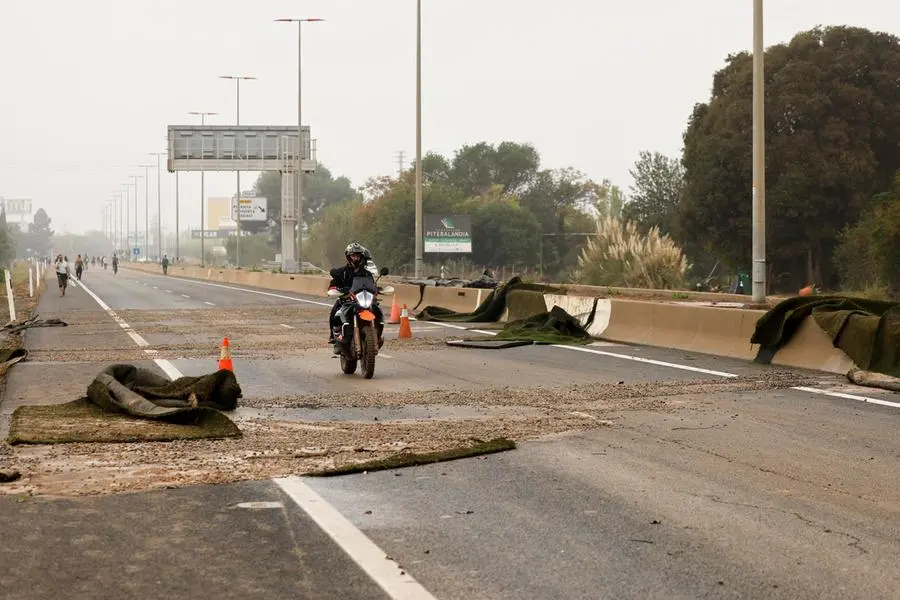 epa11691925 A motorcyclist drives along the CV-36 highway as the road network remains blocked due to damage inflicted by significant rainfall in the city of Valencia, eastern Spain, 30 October 2024. The State Meteorological Agency (AEMET) has issued red alerts for rainfall in multiple regions of the province of Valencia, caused by the severe storm DANA. The storm has impacted multiple areas of the city, resulting in the loss of at least 13 lives due to the flooding. EPA/BIEL ALINO