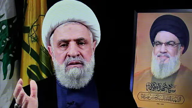 epa11692456 A photo of a screen shows Hezbollah's new leader Sheikh Naim Qassem (L) delivering a televised speech broadcasted on Hezbollah's al-Manar TV channel, in Beirut, Lebanon, 30 October 2024. Lebanon's Hezbollah on 29 October announced that its deputy leader Naim Qassem was appointed to succeed late chief Hassan Nasrallah (R). EPA/WAEL HAMZEH