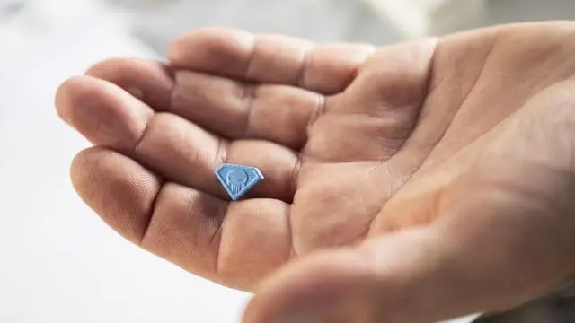 epa10118767 A man shows the MDMA drug 'punisher' during the 29th Street Parade in the city center of Zurich, Switzerland, 13 August 2022. The annual dance music event Street Parade runs this year under the motto 'THINK'. EPA/ENNIO LEANZA