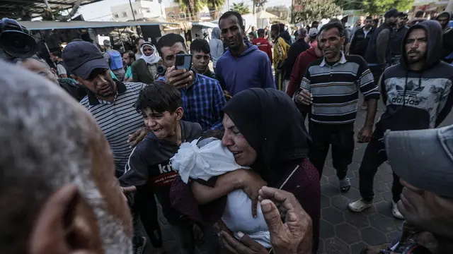 epa11690127 A Palestinian relative of two children, brothers aged one and eleven, mourns during their funeral at Al Aqsa Martyrs hospital in Deir Al Balah town, central Gaza Strip, 29 October 2024. According to the Palestinian Ministry of Health in Gaza, at least 10 Palestinians were killed in an Israeli airstrike in the Al Zawaida neighborhood overnight. More than 43,000 Palestinians, including over 13,000 children, have been killed according to the Palestinian Ministry of Health and over 1,400 Israelis have been killed according to the Israel Defense Forces (IDF), since Hamas militants launched an attack against Israel from the Gaza Strip on 07 October 2023, and the Israeli operations in Gaza and the West Bank which followed it. EPA/MOHAMMED SABER ATTENTION EDITORS: GRAPHIC CONTENT
