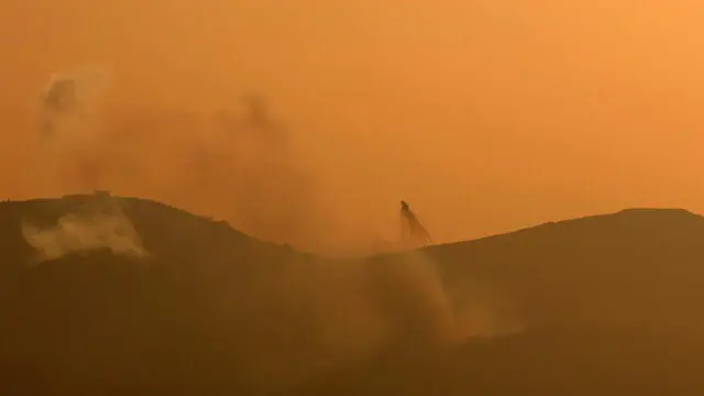 epa11474939 Smoke rises as a result of Israeli shelling on the village of Kfarkela in southern Lebanon, as seen form an undisclosed location in Upper Galilee, northern Israel, 12 July 2024. The Israeli military stated that throughout the day, numerous projectiles were identified crossing from Lebanon into the areas of Har Dov, Margaliot, and Metula in northern Israel. EPA/ATEF SAFADI