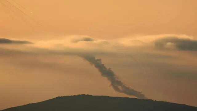 epa11655092 Projectiles are launched from southern Lebanon towards Israel, as seen from an undisclosed location in the Galilee, northern Israel, 11 October 2024. Israel's military stated that around 20 projectiles were identified crossing from Lebanon into Israeli territory in the Upper Galilee area on 11 October. Israeli fighter jets struck 'several Hezbollah launchers' from which rockets were fired toward northern Israel, the statement added. EPA/ATEF SAFADI