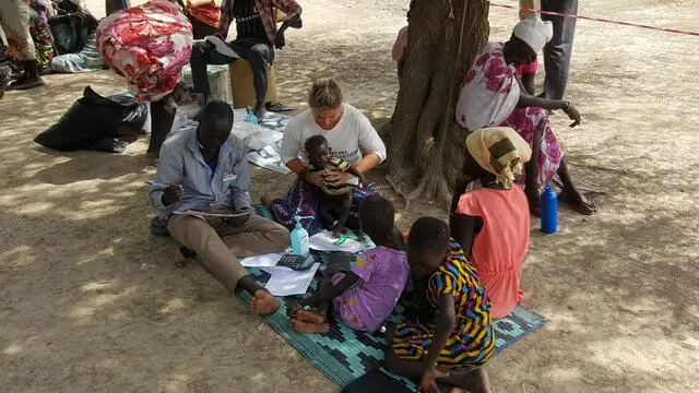 epa05807058 A handout photo made available on 21 February 2017 by Doctors without Borders (MSF) shows Philippa Pett (R), MSF doctor from the UK and Richard (L), MSF Community health worker, consulting a child suffering from malnutrition, in Dablual, South Sudan, 13 February 2017. Several United Nations agencies warned that some 100,000 people are suffering from hunger, while another million are about to face the same fate in many other territories in South Sudan, under the effect of civil war and economic collapse. Famine was declared in several areas of the Unity State in the north of the country, where estimates show that 5.5 million people will suffer from food shortage by July. EPA/NICOLAS PEISSEL HANDOUT HANDOUT EDITORIAL USE ONLY/NO SALES