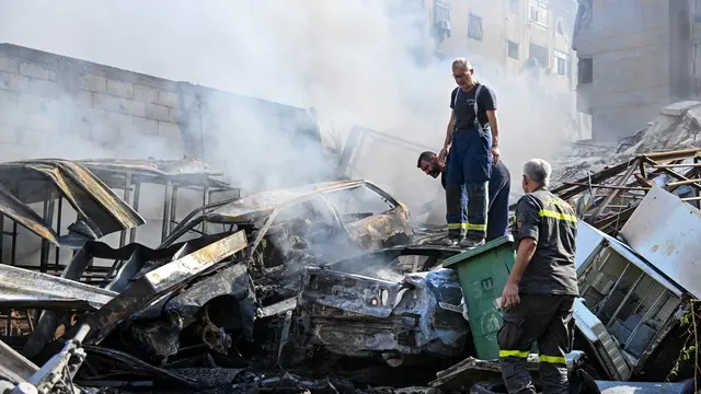 epa11696085 Firefighters work to extinguish a fire at the site of an Israeli military strike in the Kafaat area of the Dahieh district in Beirut, Lebanon, 01 November 2024. According to the Lebanese Ministry of Health, more than 2,800 people have been killed and over 13,000 others have been injured in Lebanon since the start of recent escalations of hostilities. EPA/WAEL HAMZEH