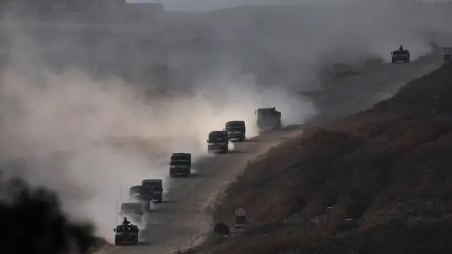 epa11312793 Israeli troops patrol the road that separates the Gaza Strip between south and north, as seen from the Israeli side of the border, Israel, 01 May 2024. More than 34,300 Palestinians and over 1,455 Israelis have been killed, according to the Palestinian Health Ministry and the Israel Defense Forces (IDF), since Hamas militants launched an attack against Israel from the Gaza Strip on 07 October 2023, and the Israeli operations in Gaza and the West Bank which followed it. EPA/ATEF SAFADI