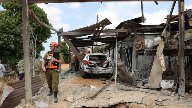 epa11647036 Israeli emergency teams work at the scene after a rocket fired from the Gaza Strip hit Kfar Habad village, near the Ben Gurion International Airport, Israel, 07 October 2024. According to IDF spokesman, at least five rockets were fired from Khan Younis in the Gaza Strip at central Israel. The day 07 October 2024 marks one year since the Palestinian militant group Hamas launched a surprise attack on Israel, killing 1,200, and one year since Israel began its war on Gaza, killing more than 41,000 and destroying the Palestinian enclave. EPA/ABIR SULTAN