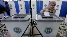 epa11699558 A Moldovan elderly woman residing in Romania casts her ballot at a polling station during the second round of the presidential elections, in downtown Bucharest, Romania, 03 November 2024. Moldova is holding the second round of presidential elections, with former Attorney General of Moldova Alexandr Stoianoglo facing incumbent President of Moldova Maia Sandu. EPA/ROBERT GHEMENT