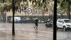 epa11692534 A person crosses a street under a heavy rain in Barcelona city, Catalonia, north-eastern Spain, 30 October 2024. An alert on rough weather in Barcelona province has being launched by Catalonia's Government on 30 October due to the forecast of wind gusts of more than 90 kilometers per hour and of over two centimeters in diameter. EPA/ALBERTO ESTEVEZ