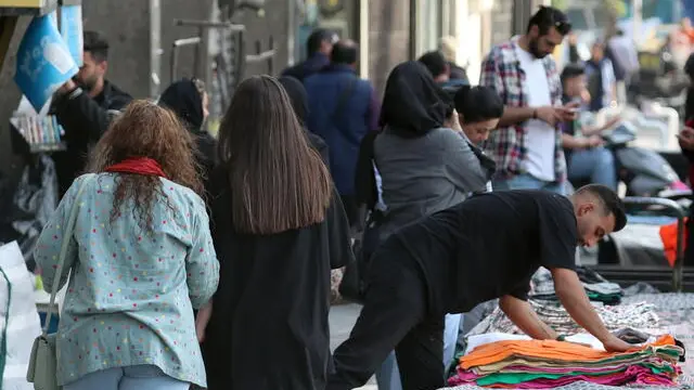 epa11276736 Women walk in the street in Tehran, Iran, 13 April 2024. According to Iranians state TV (IRIB) news agency, Iranian police are taking stricter action against violations of the Islamic dress code in public . EPA/ABEDIN TAHERKENAREH