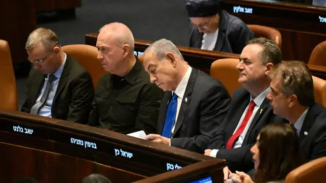 epa11689142 Israeli Prime Minister Benjamin Netanyahu (C) and Defense Minister Yoav Gallant (C-L) attend the opening of the 25th Knesset session in Jerusalem, 28 October 2024. Israel opened its Knesset session marking the anniversary of the 'Swords of Iron' war, Israel's ground operations in the Gaza Strip. More than 43,000 Palestinians and over 1,400 Israelis have been killed, according to the Palestinian Health Ministry and the Israel Defense Forces (IDF), since Hamas militants launched an attack against Israel from the Gaza Strip on 07 October 2023, and the Israeli operations in Gaza and the West Bank which followed it. EPA/DEBBIE HILL / POOL