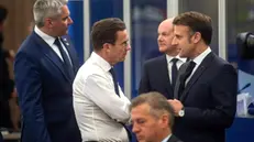 epa11709691 Swedish Prime Minister Ulf Kristersson (C) and French President Emmanuel Macron (R) chat next to Austrian Chancellor Karl Nehammer (L) and German Chancellor Olaf Scholz (2-R back) during an informal summit of the European Council at the Puskas Arena in Budapest, Hungary, 08 November 2024. The informal meeting takes place following the fifth European Political Community summit. Hungary is holding the presidency of the European Council until 31 December. EPA/ZOLTAN BALOGH HUNGARY OUT