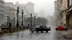 epa11706405 Cars travel along a street during heavy rains caused by the passage of hurricane Rafael, in Havana, Cuba, 6 November 2024. The eye of hurricane Rafael, a category 3 with maximum sustained winds of 185 kilometers per hour (115 miles), made landfall on the southwest coast of Cuba in the province of Artem-isa, in the middle of a massive blackout on the island, the U.S. National Hurricane Center (NHC) reported. EPA/ERNESTO MASTRASCUSA