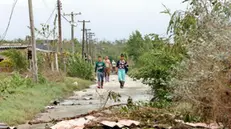 epa11708998 Some people walk along a street affected after the passage of Hurricane Rafael in Playa Majana, Cuba, 07 November 2024. The Cuban government has already indicated, shortly after Rafael passed, that the impacts concentrated in the western regions of Havana, Artemisa, and Mayabeque are 'powerful.' So far, no fatalities have been reported, as emphasized on social media by the Cuban Foreign Minister, Bruno Rodriguez. EPA/Ernesto Mastrascusa