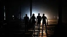 epaselect epa11673371 People walk down a street during a blackout, in Havana, Cuba, 20 October 2024 (issued 21 October 2024). The restoration of electricity in the affected areas of Cuba, including Havana, is in progress, after Cuba's Ministry of Energy and Mines reported on 20 October a third total failure of the National Electric System (SEN) in less than three days. EPA/ERNESTO MASTRASCUSA