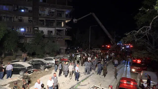 epa11649797 Syrian soldiers and people inspect the damage after missiles fell on the building in the Al-Mazzeh neighborhood in Damascus, Syria, 08 October 2024. At least seven people were killed and 11 others injured after three Israeli missiles targeted a residential building in Damascus, according to Syrian state news agency SANA, adding that rescuers are still working at the site of the strike. Israel did not immediately comment on the strike. EPA/STRINGER