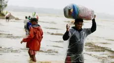 epa11714413 A villager carries belongings to safer grounds as he evacuates from their homes along a swollen river caused by heavy rains from Typhoon Toraji in Ilagan city, Isabela province, Philippines, 11 November 2024. Philippine Interior Secretary Jonvic Remulla ordered the evacuation of 2,500 villages in the direct path of Typhoon Toraji, the fourth typhoon to hit the country in a month. EPA/FRANCIS R. MALASIG