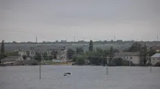 epa10687317 Rescue workers cross the flooded road leading to the village of Novovasylivka, Mykolaiv region, Ukraine, 12 June 2023. Ukraine has accused Russian forces of destroying a critical dam and hydroelectric power plant on the Dnipro River in the Kherson region along the front line in southern Ukraine on 06 June. The villages of Novovasylivka and Afanasiivka had turned into islands as territories around the Inhulets River in the Mykolaiv region were flooded. EPA/STAS KOZLIUK