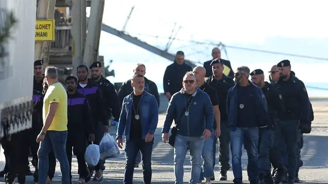 epaselect epa11709512 A group of migrants (L) intercepted in international waters around Italy, disembark the Italian Navy vessel Libra at Shengjin, Albania, 08 November 2024. Italy has sent a group of 8 migrants to Albania, after a previous group was turned away in October for failing the vetting process, in a plan aimed at deterring dangerous sea crossings by processing asylum claims outside the EU. The initiative faced legal setbacks after Italian courts ruled that migrants could not be held in Albania due to concerns over their legal status. In response, the Italian government adjusted the legal framework, hoping this would strengthen the policy, which allows up to 3,000 non-vulnerable men to be housed temporarily in Italian-run facilities in Albania. EPA/MALTON DIBRA