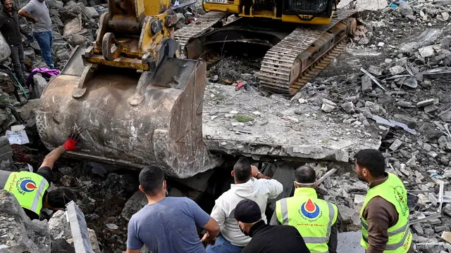 epa11713086 Rescuers and civilians use an excavator to search the rubble for survivors and victims at a site targeted by an Israeli airstrike, in Almat, Jbeil District, Lebanon, 10 November 2024. The Lebanese Health Ministry's Emergency Operations Center stated that at least 23 people were killed, including seven children, and six others were injured as a result of the Israeli strike on Almat. According to the Lebanese Ministry of Health, more than 3,100 people have been killed and over 13,900 others injured in Lebanon since the escalation in hostilities between Israel and Hezbollah. EPA/WAEL HAMZEH