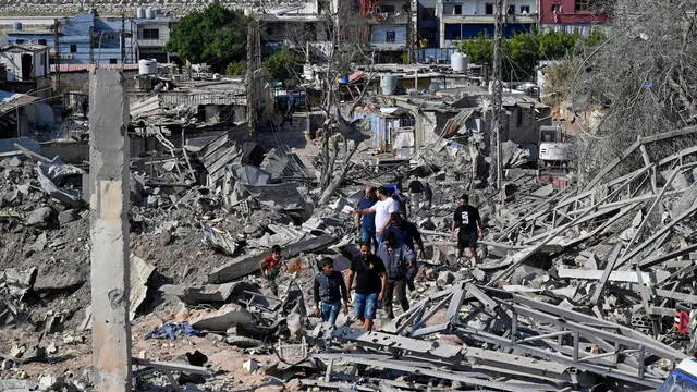 epa11707069 People inspect the damage at the site of an Israeli airstrike on the Ouzai area near Beirut Airport's runway, in south Beirut, Lebanon, 07 November 2024. According to the Lebanese Ministry of Health, more than 3,000 people have been killed and over 13,600 others injured in Lebanon since the escalation in hostilities between Israel and Hezbollah. EPA/WAEL HAMZEH