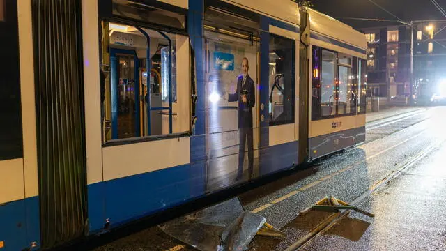 epa11715449 A broken streetcar stands on the track after a group caused a commotion on Plein 40-45 in Amsterdam Nieuw-West, The Netherlands, 11 November 2024. In the disturbances, a burning object landed on a streetcar and caught fire, but was extinguished. There were no people in the streetcar and no injuries were reported. EPA/TALHA ANDAC