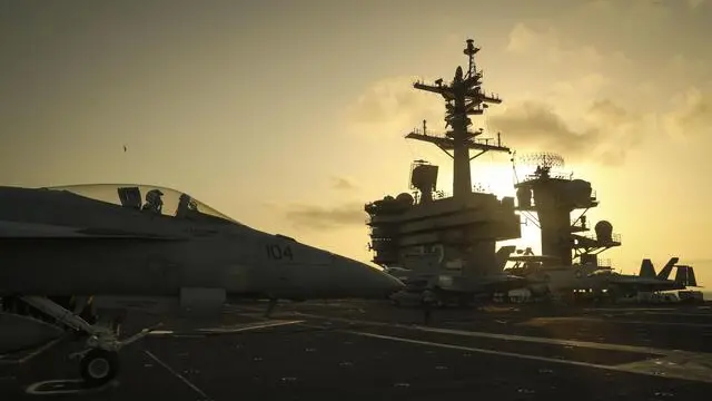 epa07632522 A handout photo made available by the US Navy shows the sun setting behind the Nimitz-class aircraft carrier USS Abraham Lincoln (CVN 72), in the Arabian Sea, 03 June 2019 (reissued 07 June 2019). The Abraham Lincoln Carrier Strike Group (CSG) 12 is deployed in the region amid heightened tensions between the US and Iran, with both saying they don't seek war. EPA/US NAVY/MC 3RD CLASS JEFF SHERMAN HANDOUT HANDOUT EDITORIAL USE ONLY/NO SALES