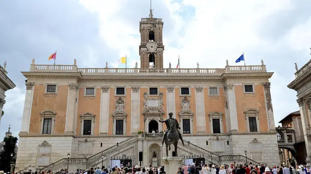 Pope Francis (C-L) is flanked by Rome's Mayor Roberto Gualtieri (C-R), blesses the faithful from a balcony during his visit to Campidoglio (Capitoline hill) in Rome, Italy, 10 June 2024. ANSA/ETTORE FERRARI