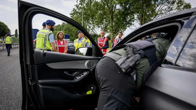 epa11534422 Dutch Minister Marjolein Faber (C) examines the operations of the military police during a check at the border of the Netherlands at Zevener, the Netherlands, 07 August 2024. Checks are being conducted at the former border crossing along the A12 to limit the influx of illegal crossings. Minister Faber aims to increase border surveillance to reduce the number of illegal crossings. According to the government report 'Staat van Migratie 2024,' 145,000 people were checked by these mobile border surveillances in 2023, out of which 720 individuals were found to have crossed the border illegally. EPA/EMIEL MUIJDERMAN