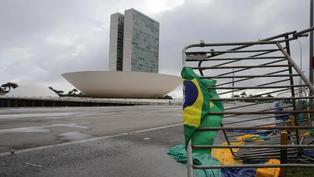 epa10396832 Damaged fences on the outskirts of the Planalto Palace, with the Congress in the background, after Bolsonaro protesters took over the Plaza de los Tres Poderes (Square of the Three Powers) to invade government buildings, in Brasilia, Brazil, 09 January 2023. Hundreds of supporters of former Brazilian President Jair Bolsonaro on 08 January invaded the headquarters of the National Congress, and also Supreme Court and the Planalto Palace, seat of the Presidency of the Republic, in a demonstration calling for a military intervention to overthrow President Luiz Inacio Lula da Silva. The crowd broke through the cordons of security forces and forced their way to the roof of the buildings of the Chamber of Deputies and the Senate, and some entered inside the legislative headquarters. So far, authorities detained some people involved in the violent acts which were widely condemned by all Brazilian institutions and by the international community. EPA/ANDRE COELHO