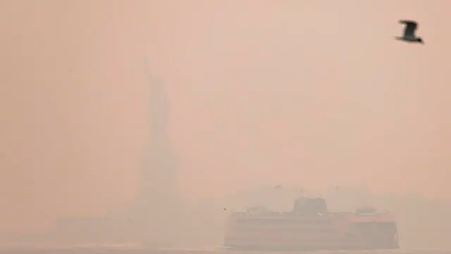 epa10678570 The Statue of Liberty and the Staten Island Ferry are obscured by smoke from wildfires burning in Canada over Manhattan in New York, New York, USA, 07 June 2023. All of New York City is under an air quality alert as result of the smoke, which is affecting large portions of the northeastern United States. EPA/JUSTIN LANE