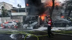 epa11715117 Israeli firefighters work to extinguish a fire after rockets fired from Lebanon hit the city of Kiryat Ata, Haifa District, northern Israel, 11 November 2024. The Israeli military stated that around 90 projectiles crossed from Lebanon into northern Israel, on 11 November, adding that most of them were intercepted by Israel's Iron Dome air defense system. According to the Magen David Adom (MDA), Israel's national emergency services, two people injured in the rocket hit in Kiryat Ata have been evacuated to Rambam hospital. EPA/GIL NECHUSHTAN ISRAEL OUT