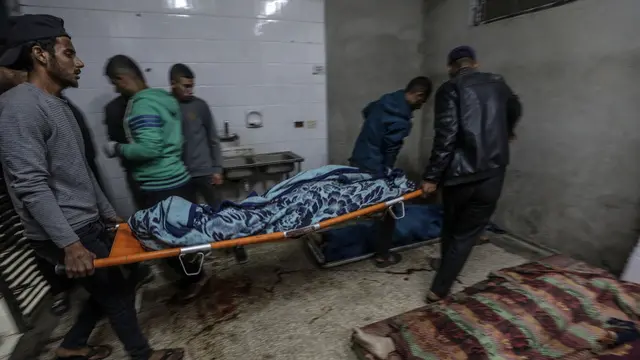 epa11724969 People carry the bodies of five members of the same family who were killed in an Israeli airstrike in the west of the Al-Nusairat refugee camp, at the morgue of the Al-Aqsa Martyrs hospital, in Deir Al Balah town, central Gaza Strip, 16 November 2024. More than 43,800 Palestinians, including over 13,000 children, have been killed according to the Palestinian Ministry of Health and over 1,400 Israelis have been killed according to the Israel Defense Forces (IDF), since Hamas militants launched an attack against Israel from the Gaza Strip on 07 October 2023, and the Israeli operations in Gaza and the West Bank which followed it. EPA/MOHAMMED SABER