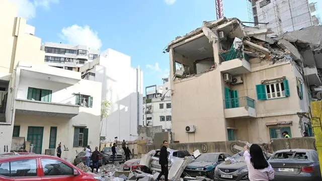 epa11725664 People survey damage near the site of an Israeli airstrike in Ras Al Naba'a neighborhood of Beirut, Lebanon 17 November 2024. According to the Lebanese Ministry of Health, one person was killed and three others injured in the airstrike. According to the Lebanese Ministry of Health, more than 3,450 people have been killed and over 14,650 others have been injured in Lebanon since the escalation in hostilities between Israel and Hezbollah. EPA/WAEL HAMZEH