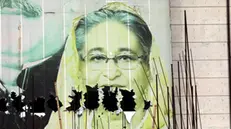 epa11529473 A vandalized image of Prime Minister Sheikh Hasina in the aftermath of her resignation, in Dhaka, Bangladesh, 06 August 2024. In an address to the nation, Chief of Army Staff General Waker-Uz-Zaman announced on 05 August that Prime Minister Sheikh Hasina has resigned after weeks of unrest and an interim government will be formed to run the country. A new curfew starting 06:00 p.m. local time was imposed on 04 August by Dhaka authorities following the initial one imposed by the Bangladeshi government on 20 July 2024, as casualties mounted and law enforcement struggled to contain the unrest. Violence broke out in Dhaka and other regions following student-led protests demanding reforms to the government's job quota system. EPA/MONIRUL ALAM