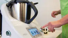 epa04759890 A woman uses a Thermomix TM5 on the sidelines of Vorwerk Group company balance sheet conference in Duesseldorf, Germany, 21 May 2015. EPA/MARIUS BECKER