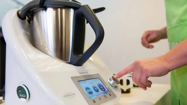 epa04759890 A woman uses a Thermomix TM5 on the sidelines of Vorwerk Group company balance sheet conference in Duesseldorf, Germany, 21 May 2015. EPA/MARIUS BECKER