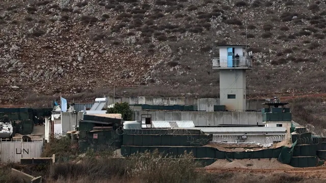 epa11729358 A UNIFIL (United Nations Interim Force in Lebanon) soldier at an obervation tower at the UN base, located next to the Lebanese village of Maroun Al Ras, as seen from Avivim on the Israeli side of the border on 19 November 2024. The Israeli army reported that the 98th Division has begun conducting targeted raids based on intelligence against Hezbollah in southern Lebanon. According to the Lebanese Ministry of Health, more than 3,500 people have been killed and over 14,900 others have been injured in Lebanon since the escalation in hostilities between Israel and Hezbollah. EPA/ATEF SAFADI