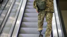 epaselect epa11403626 A participant with a prosthetig leg and wearing military camouflage stands on an escalator during the Ukraine Recovery Conference 2024 in Berlin, Germany, 11 June 2024. The Ukraine Recovery Conference 2024 takes place in Berlin from 11 to 12 June 2024, under the slogan 'United in defense. United in recovery. Stronger together.' EPA/CLEMENS BILAN