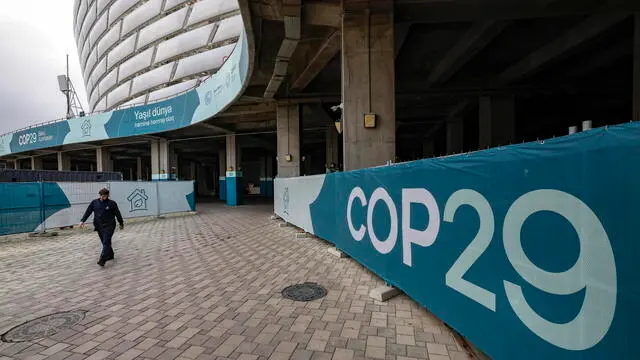 epa11730557 A man passes an installation with the COP 29 logo near the venue of the United Nations Climate Change Conference COP29 in Baku, Azerbaijan, 20 November 2024. The Azerbaijani capital of Baku hosts the 2024 United Nations Climate Change Conference (COP29) from 11 to 22 November 2024. EPA/ANATOLY MALTSEV