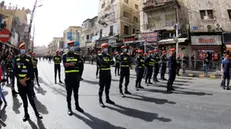 epa11682504 Security forces watch people shouting slogans and carry placards during a pro-Palestinian during a protest in support of the Lebanese and Palestinian people, in Amman, Jordan, 25 October 2024. EPA/MOHAMED ALI